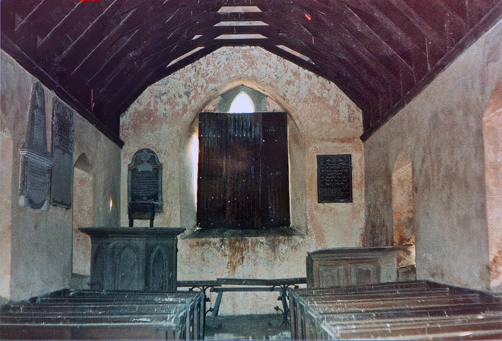 Inside St Illtyd church showing the font and  priests table
